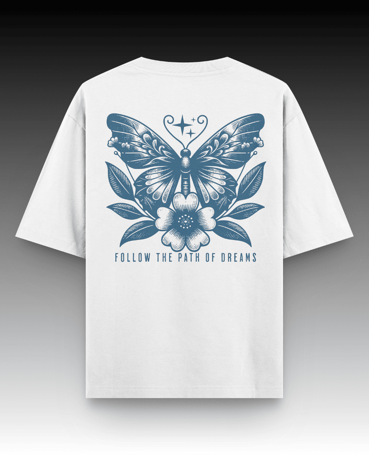 White oversized t-shirt featuring 'Dreams' text graphic. Designed with a drop shoulder and relaxed fit, this stylish t-shirt offers ultimate comfort and a chic, laid-back vibe