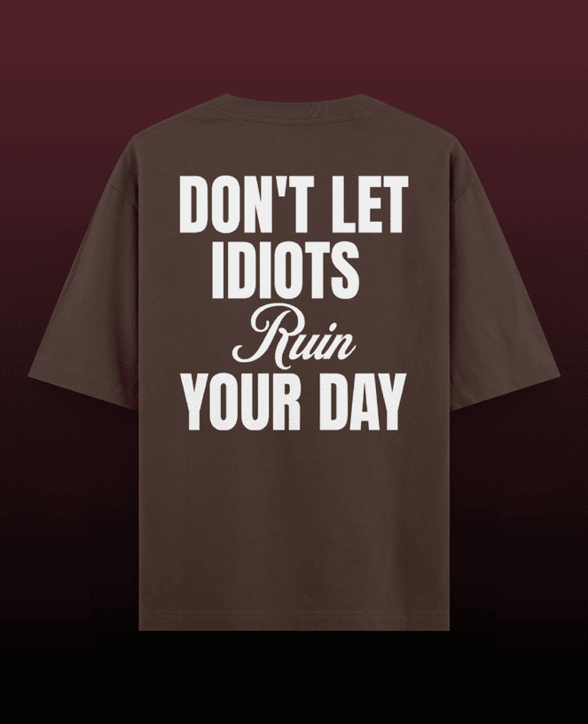Black oversized t-shirt with a bold 'Idiots' graphic on the front. Features a relaxed fit, drop shoulder design, and casual streetwear vibe. Ideal for comfortable, laid-back style with a statement-making look.